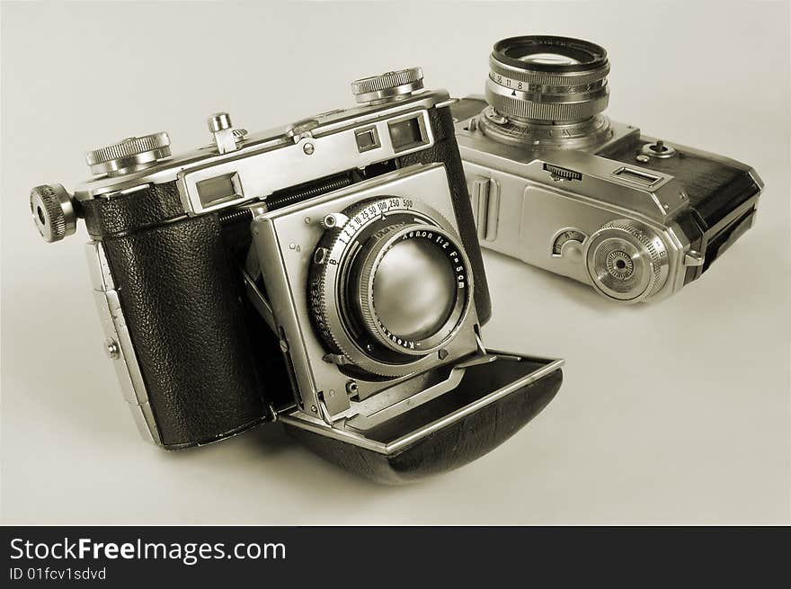 Two antiquarian 35-mm film cameras with put-forward lens. Two antiquarian 35-mm film cameras with put-forward lens.