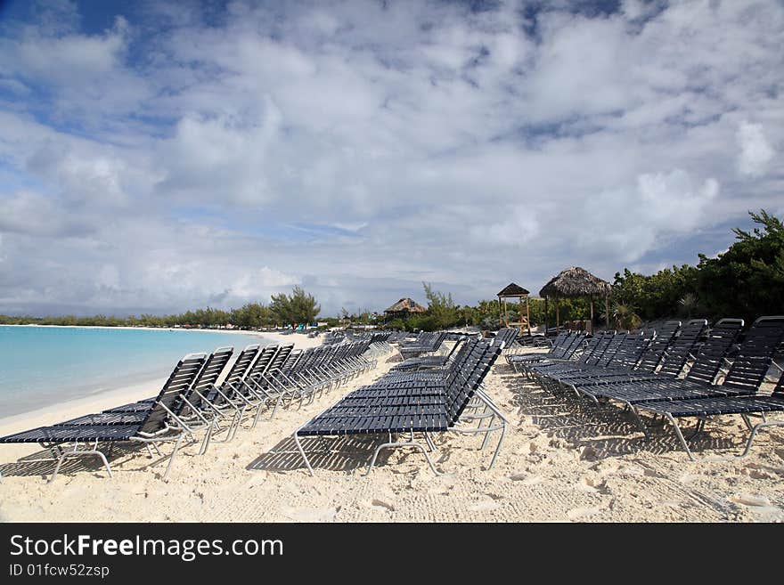 Aqua blue beach ocean with many chairs for relaxing. Aqua blue beach ocean with many chairs for relaxing