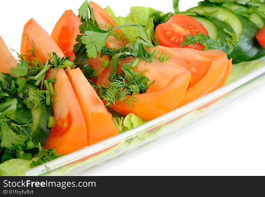 Tomatoes and cucumbers in a glass dish. Tomatoes and cucumbers in a glass dish