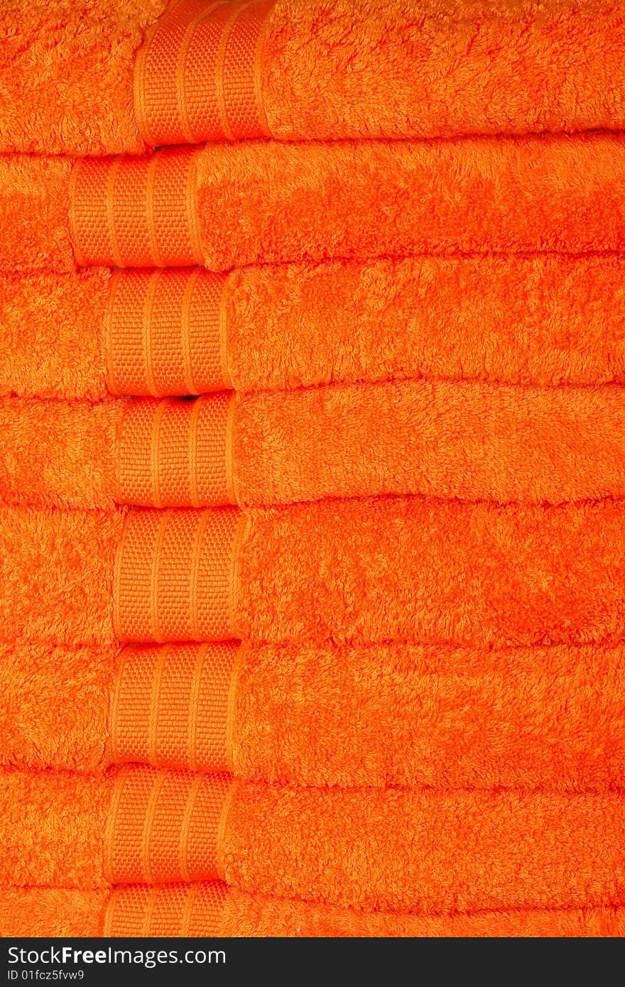 Big pile of soft thick orange towels