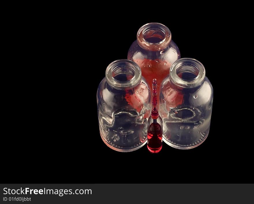 Two empty vials, one with red medicine and an ampule. Two empty vials, one with red medicine and an ampule