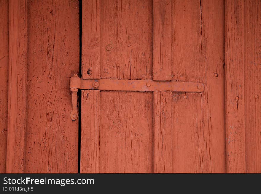 Closeup of red hinge on a red shed. Closeup of red hinge on a red shed