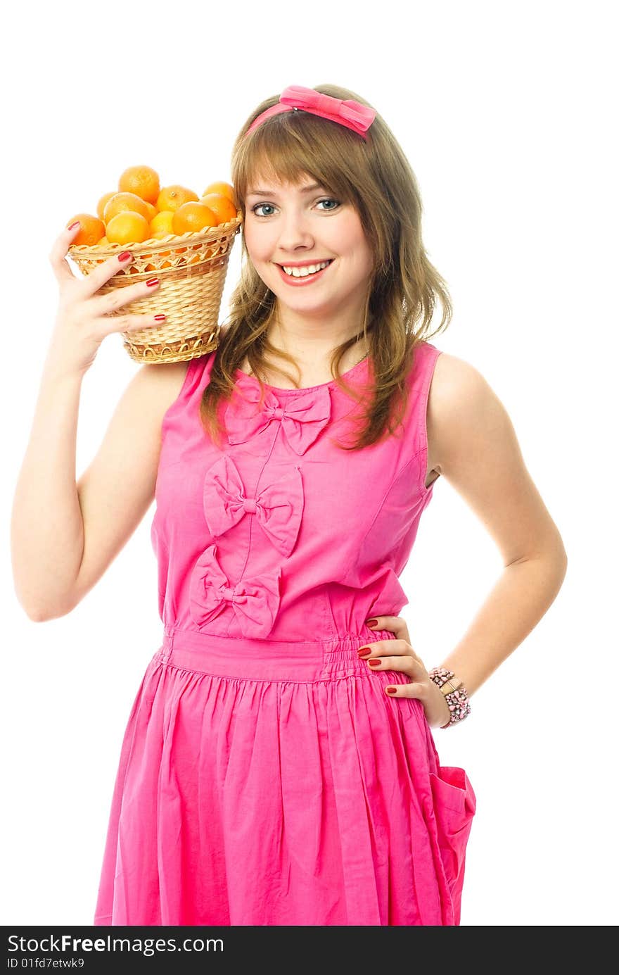 Portrait of a beautiful young woman dressed in pink with a basket full of tangerines. Portrait of a beautiful young woman dressed in pink with a basket full of tangerines