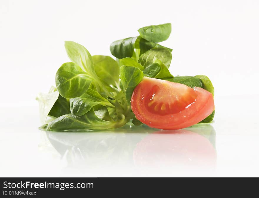 Fresh basil leaves and tomato on white background