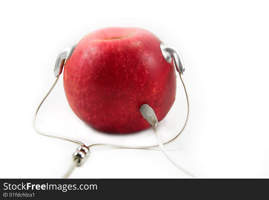 Red apple with earphones like player isolated on white. Red apple with earphones like player isolated on white