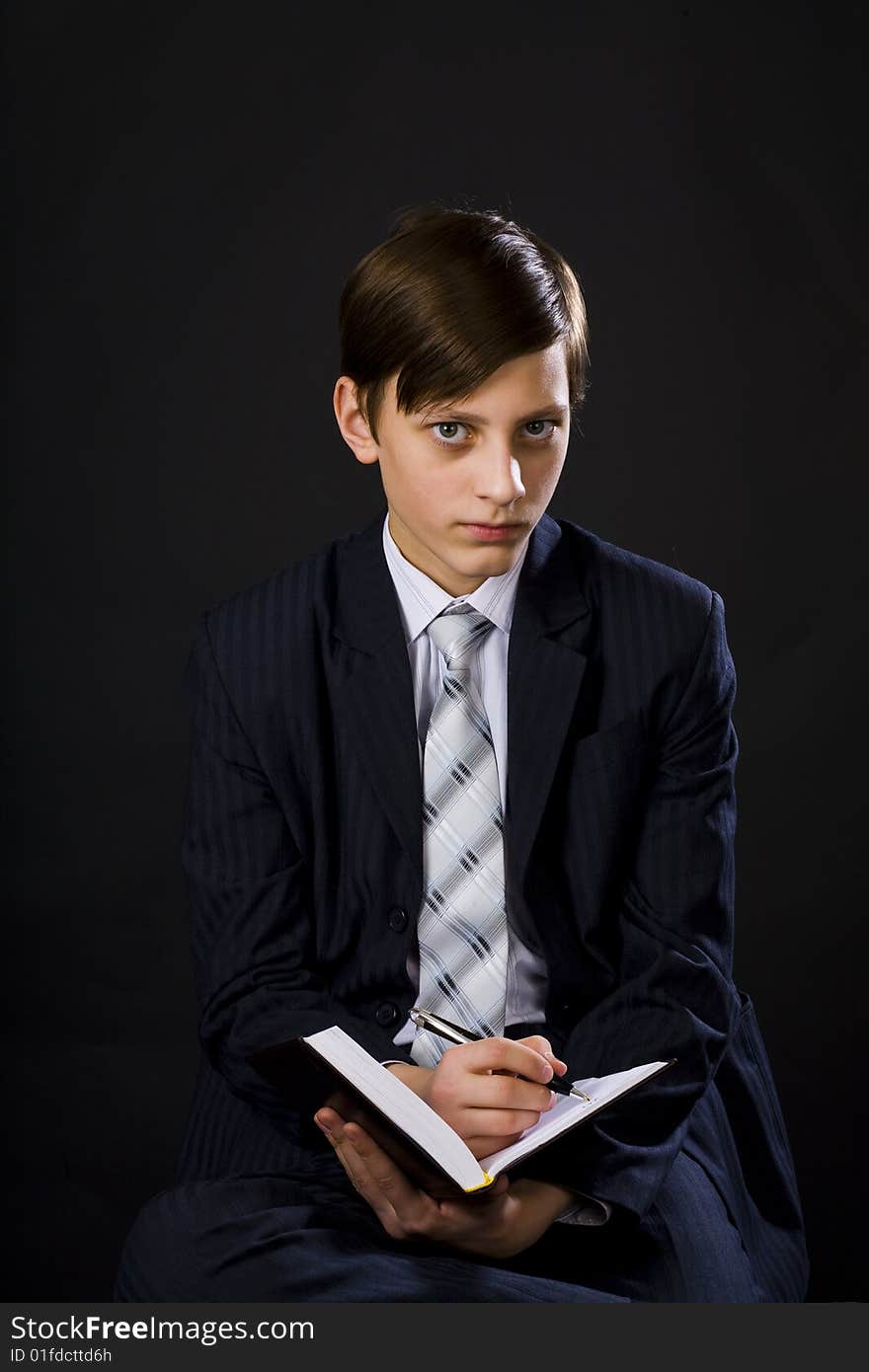 Young businessmen in suit and tie with notebook and pen