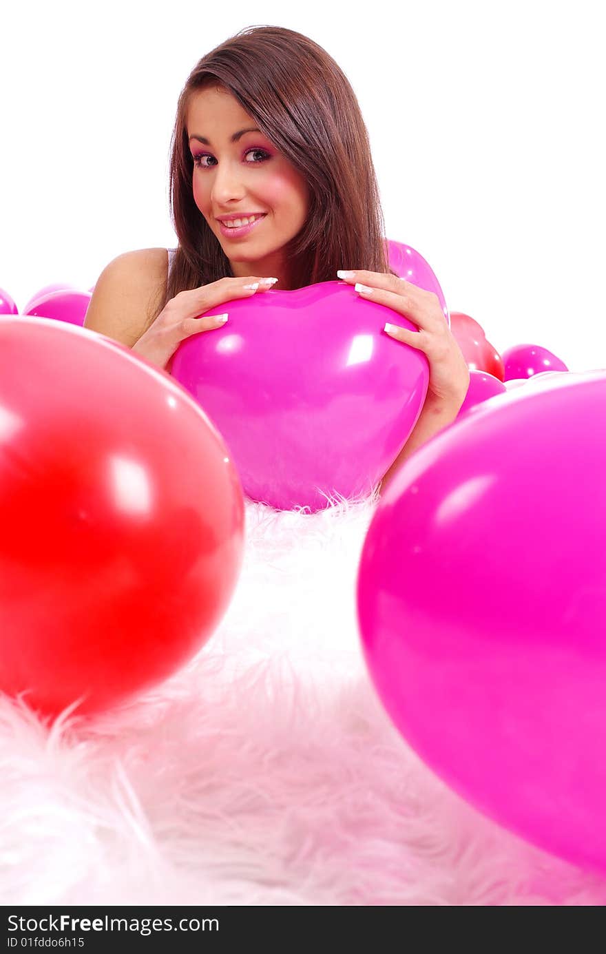 Woman lying on floor among balloons