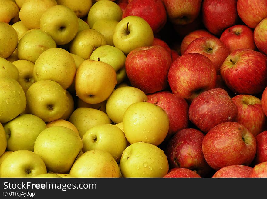 A close up photo of a bunch of red and yellow apples