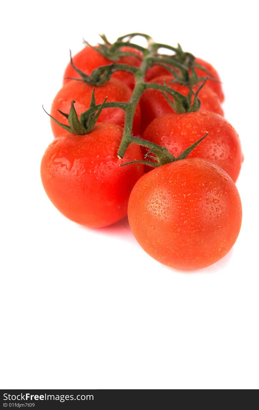 Macroshot of a bunch of tomatoes with drops of water. Isolated over white background. Lot of copyspace. Macroshot of a bunch of tomatoes with drops of water. Isolated over white background. Lot of copyspace.