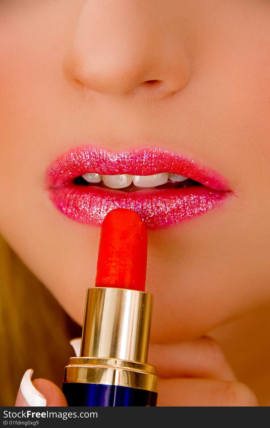 Close view of model applying lipstick