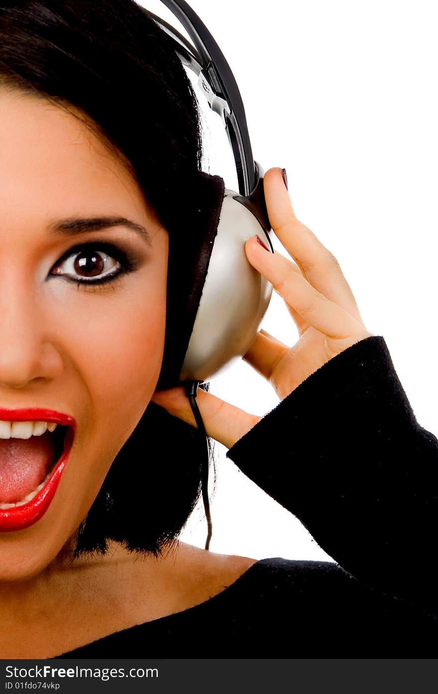 Portrait of happy young female listening music