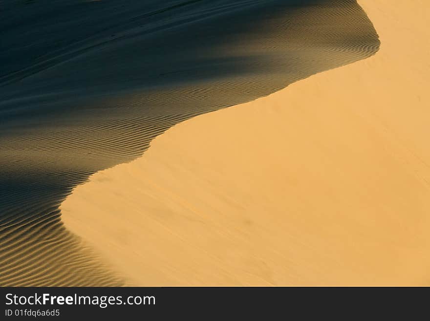 Stockton sand dunes in Anna Bay, NSW, Australia. Sand ripples detail with dramatic shadows. Taken in low light conditions.