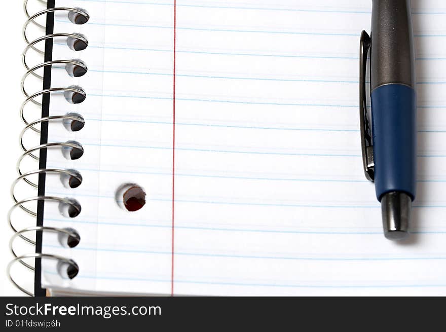 A macro picture of a pen and notebook. A macro picture of a pen and notebook