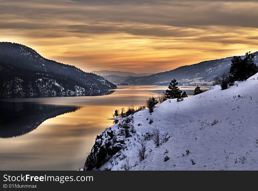 Reflected sunset over snowy lake and mountain view. Reflected sunset over snowy lake and mountain view.