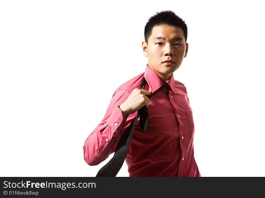 Stylish asian young man in pink shirt untying black tie. Stylish asian young man in pink shirt untying black tie