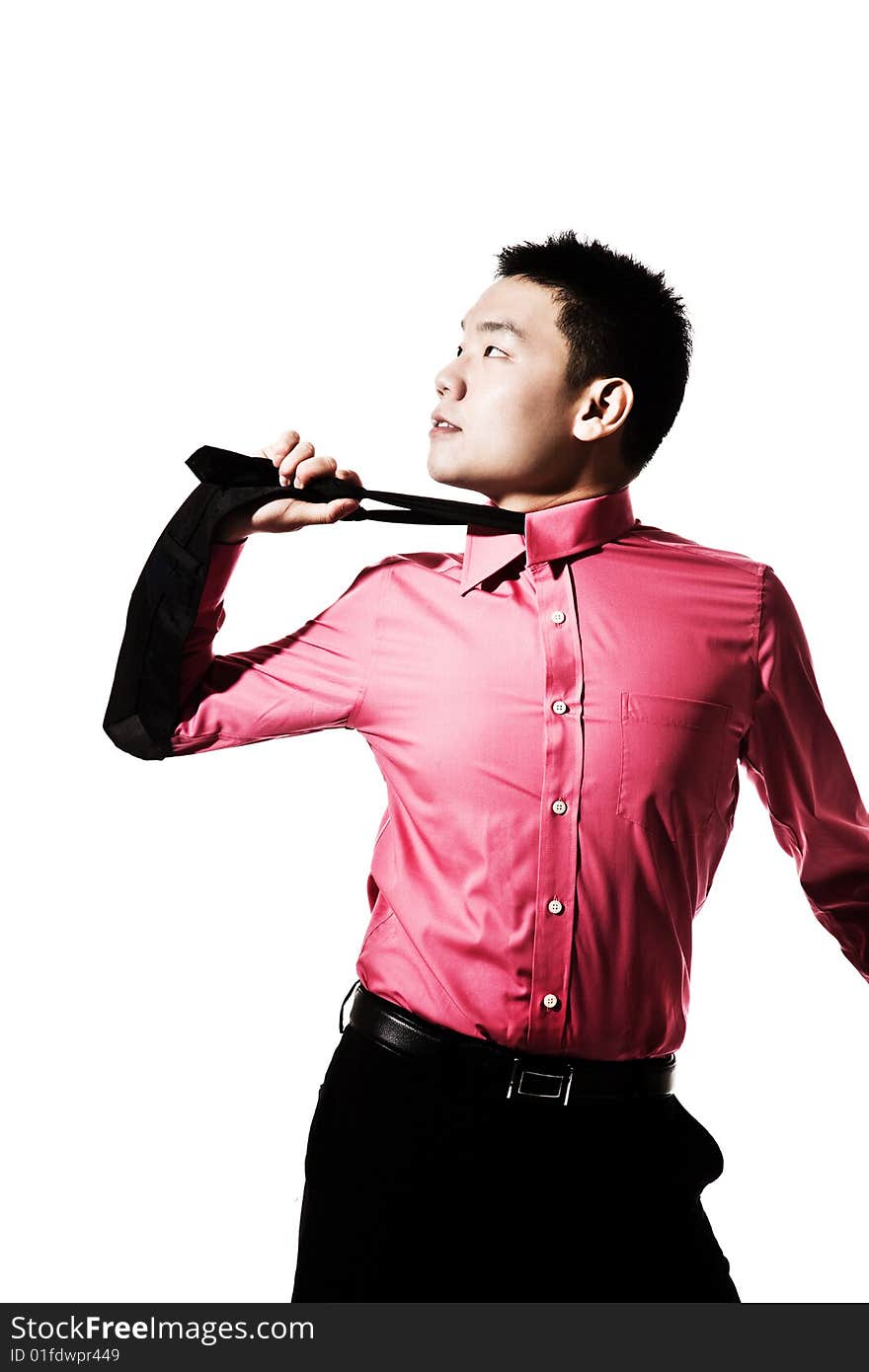 Stylish asian young man pulling the tie on his neck. Stylish asian young man pulling the tie on his neck