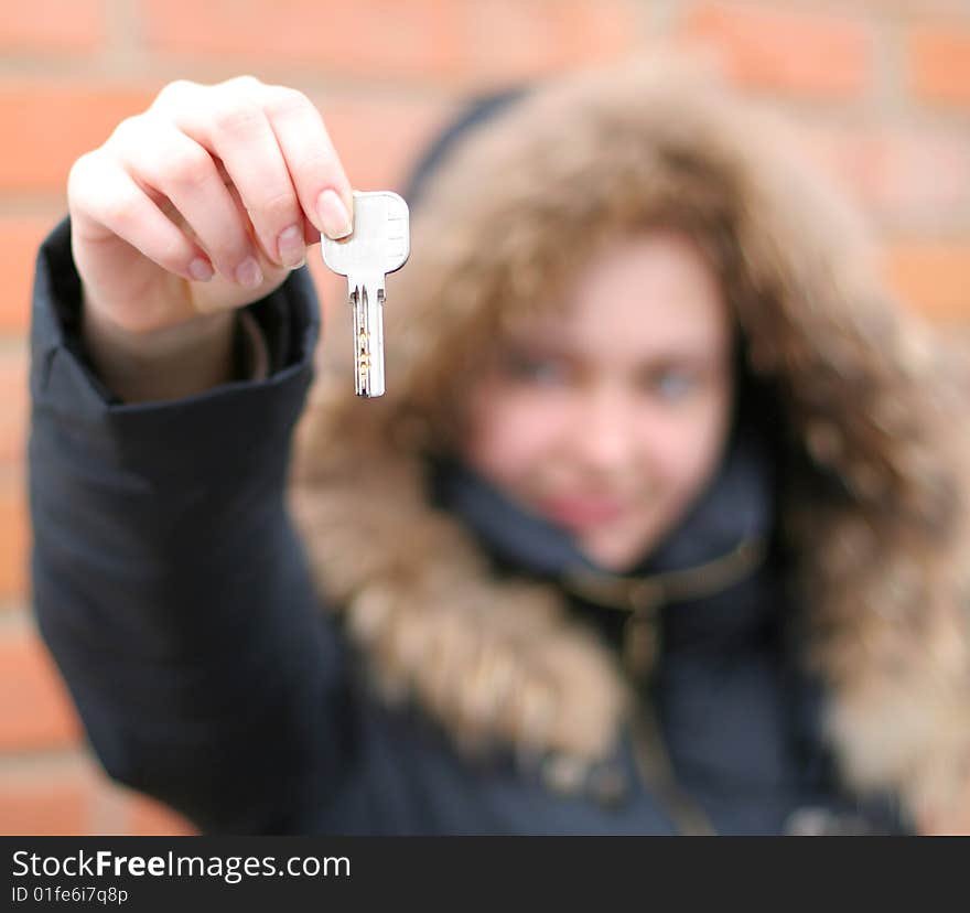 Hand holds a key (key in focus)