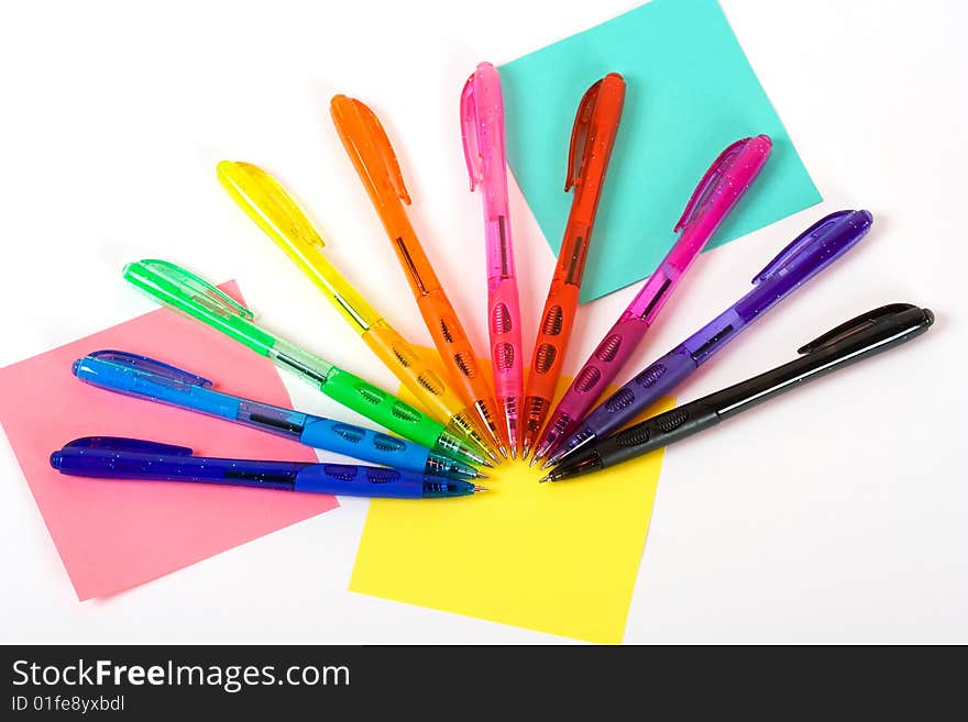 A photo of ten plastic pens of different colors. A photo of ten plastic pens of different colors