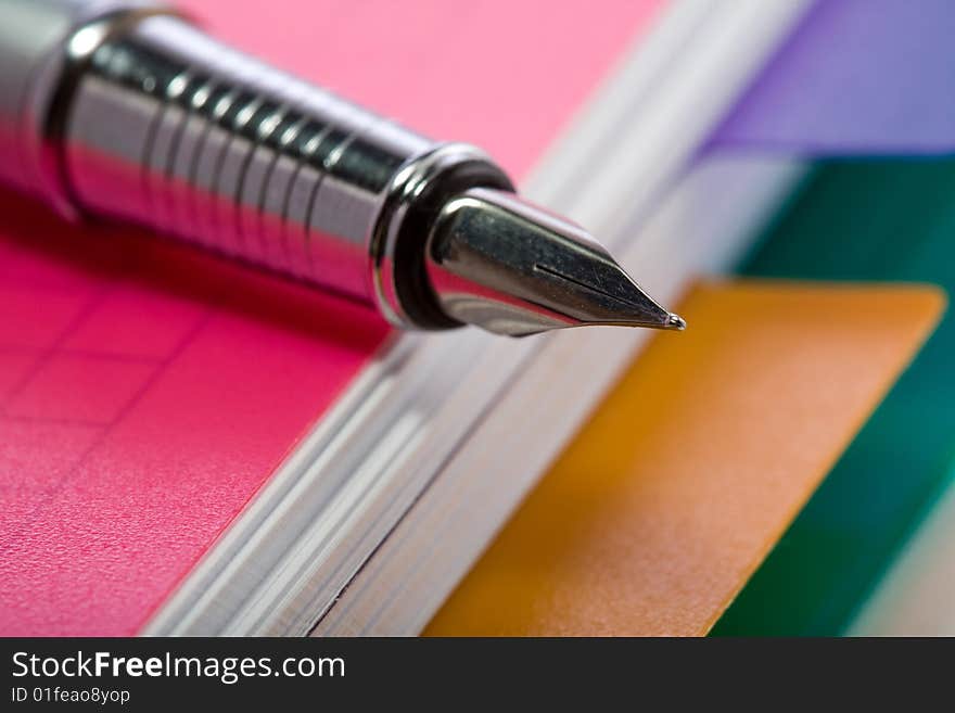 Stock photo: an image of a fountain pen on a notebook