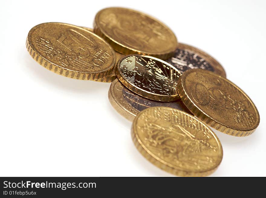 A pile of euro coins on a white background