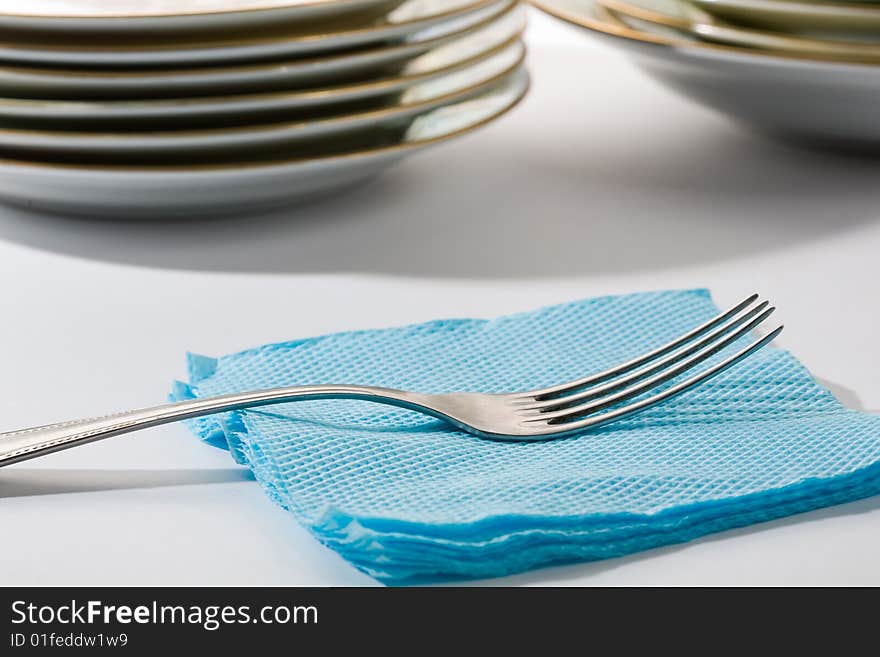 Stock photo: an image of silver fork on blue napkin