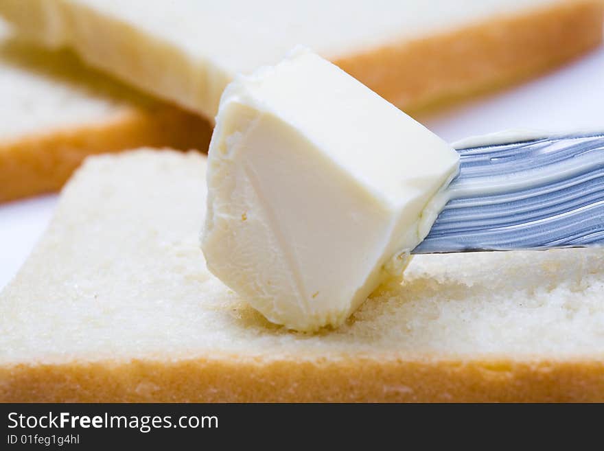 Stock photo: an image of fresh butter on a knife and  bread. Stock photo: an image of fresh butter on a knife and  bread