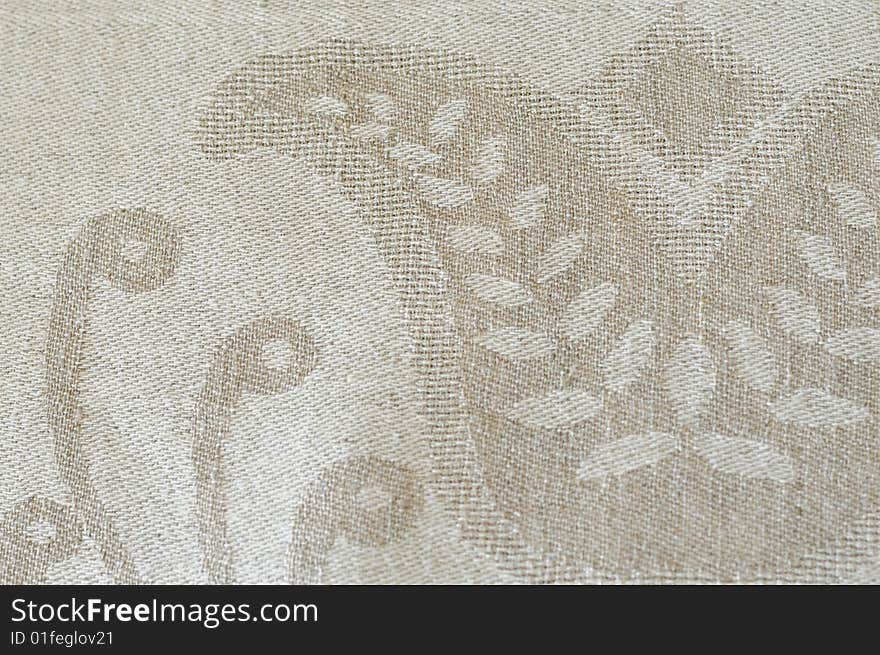 A detail of gray linen fabric with woven  ornaments. A detail of gray linen fabric with woven  ornaments