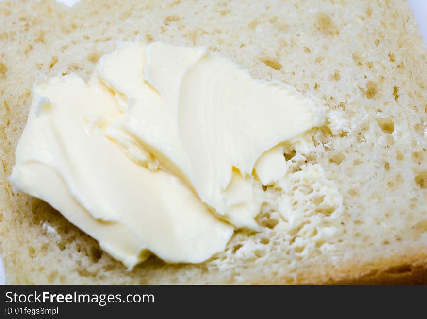 Stock photo: an image of yellow fresh butter on bread