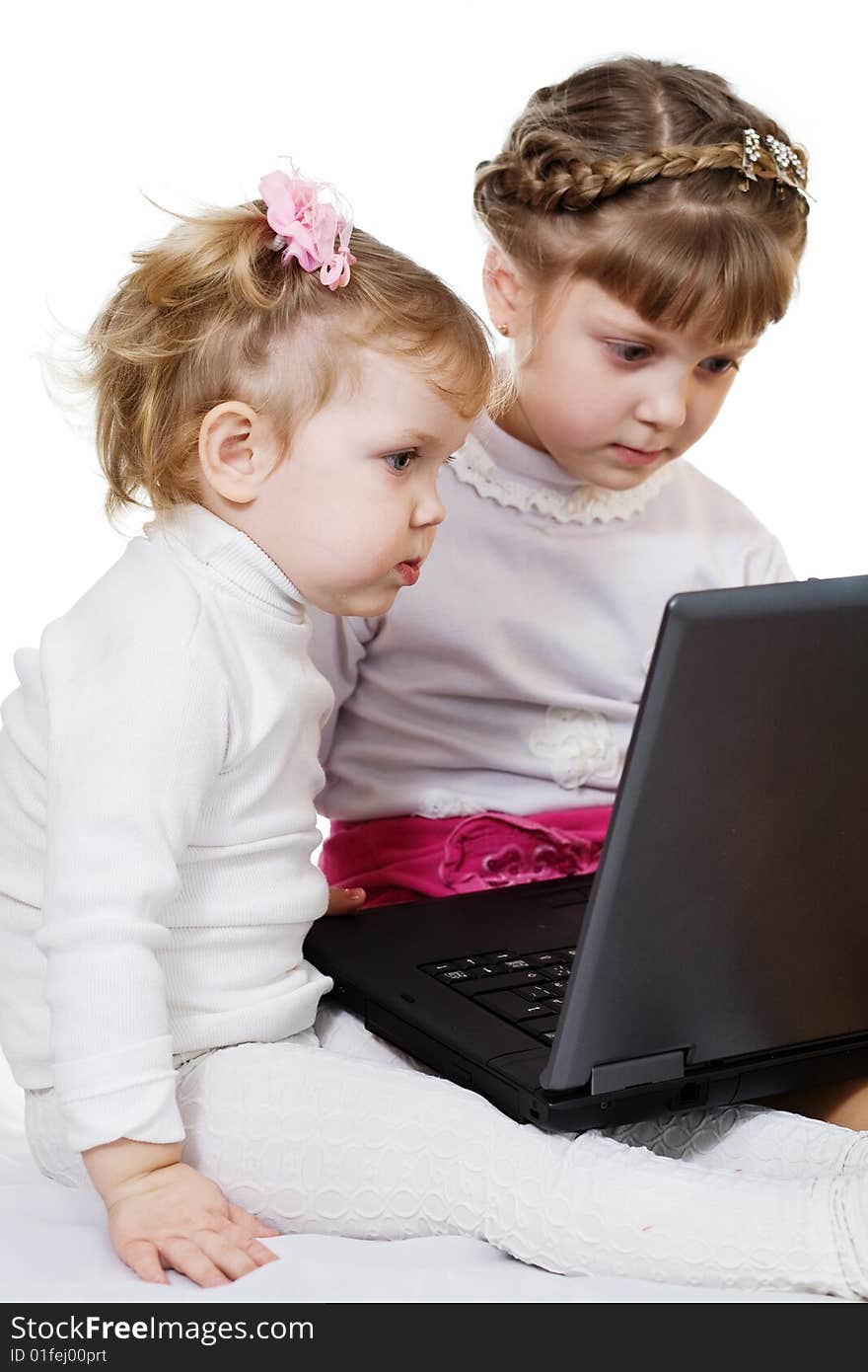 Stock photo: an image of two little girls with laptop. Stock photo: an image of two little girls with laptop