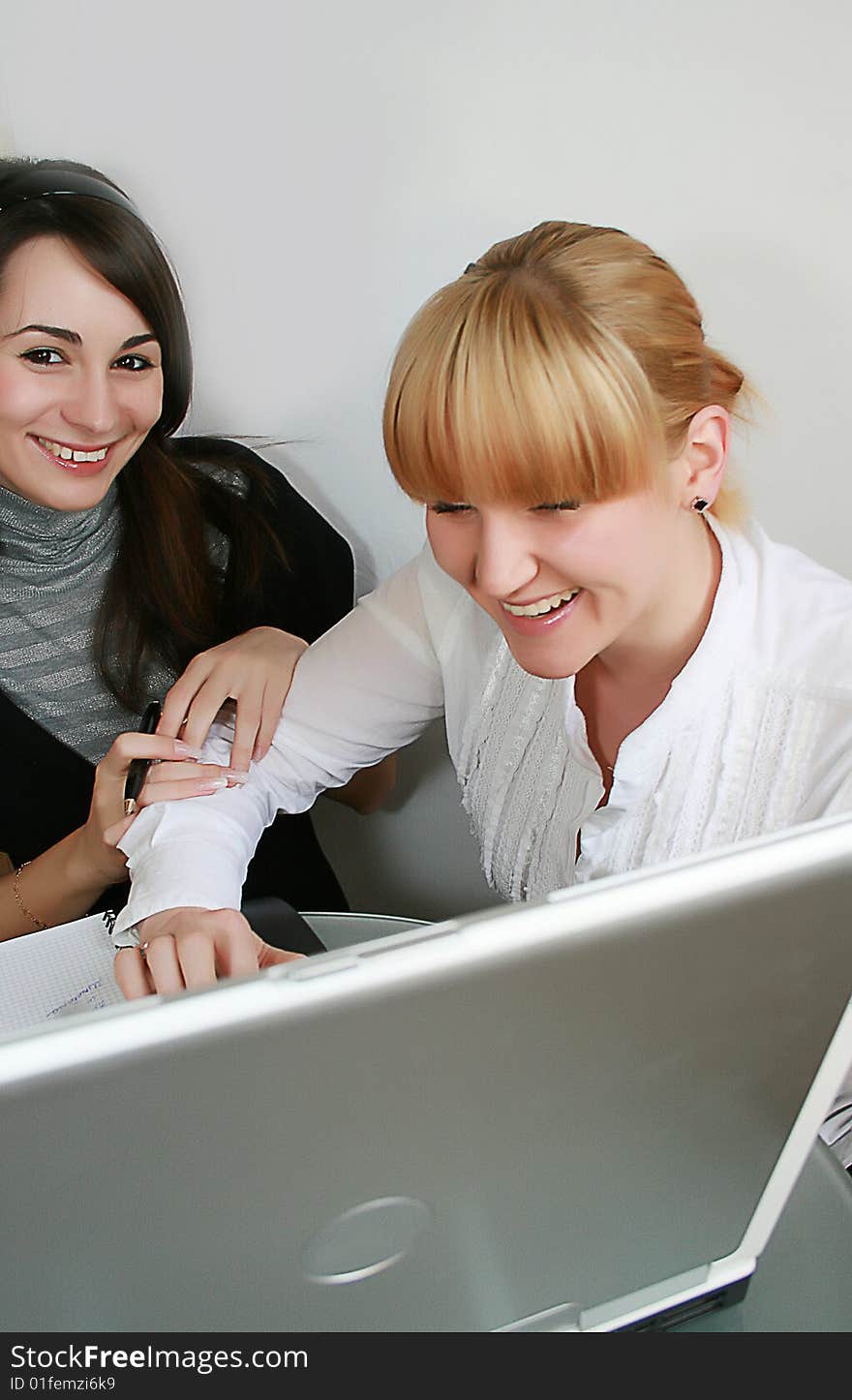 Two young business partners working in office. Two young business partners working in office.