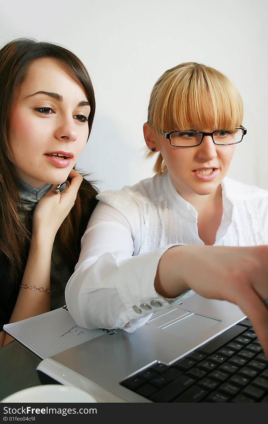 Two young business partners working in office. Two young business partners working in office.