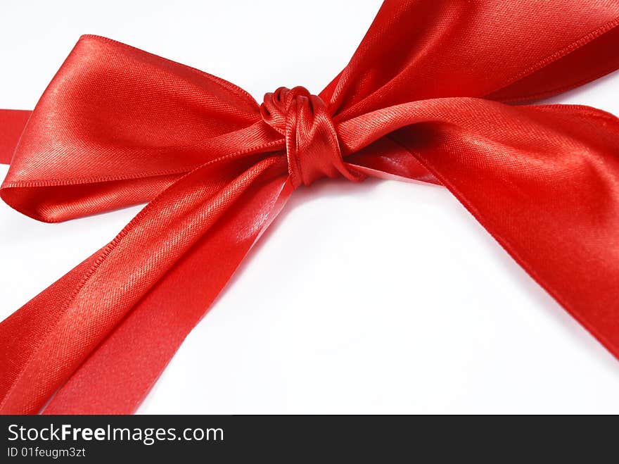 Red holiday bow on white background