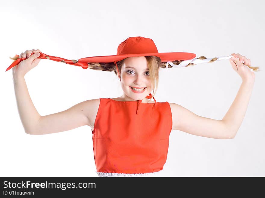 Joking girl with pigtails in red hat