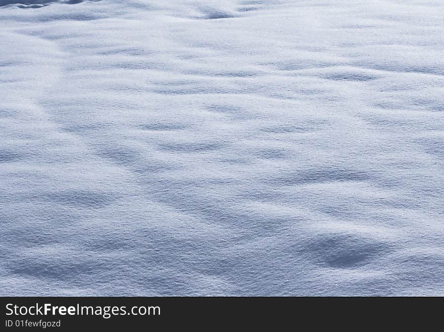 A simple view of an expanse of undulating snow. A simple view of an expanse of undulating snow