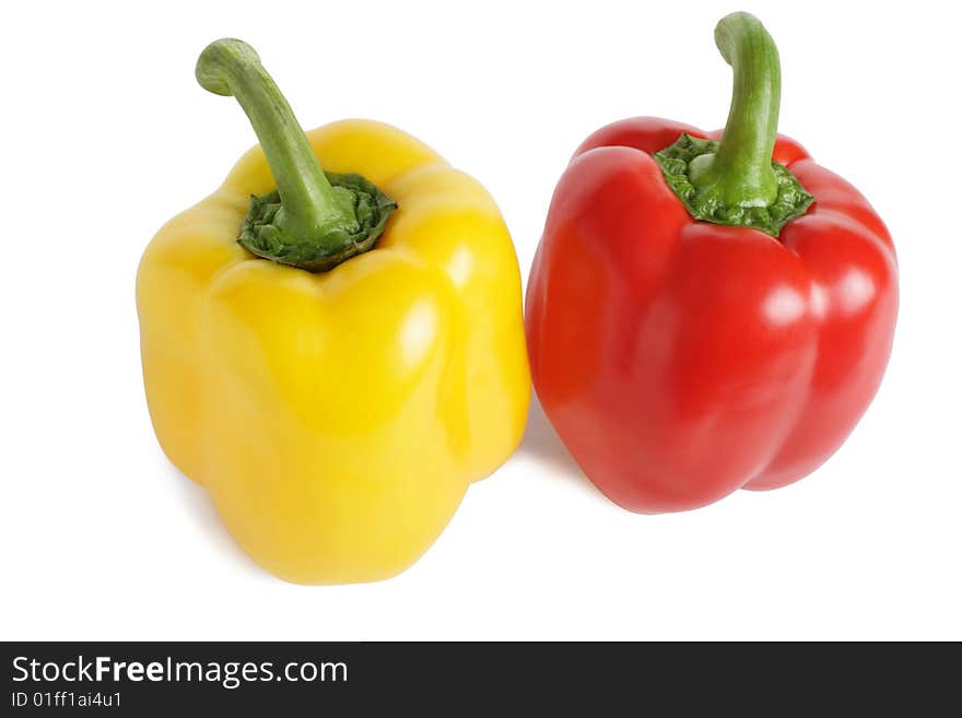 Red and yellow peppers are isolated on a white background