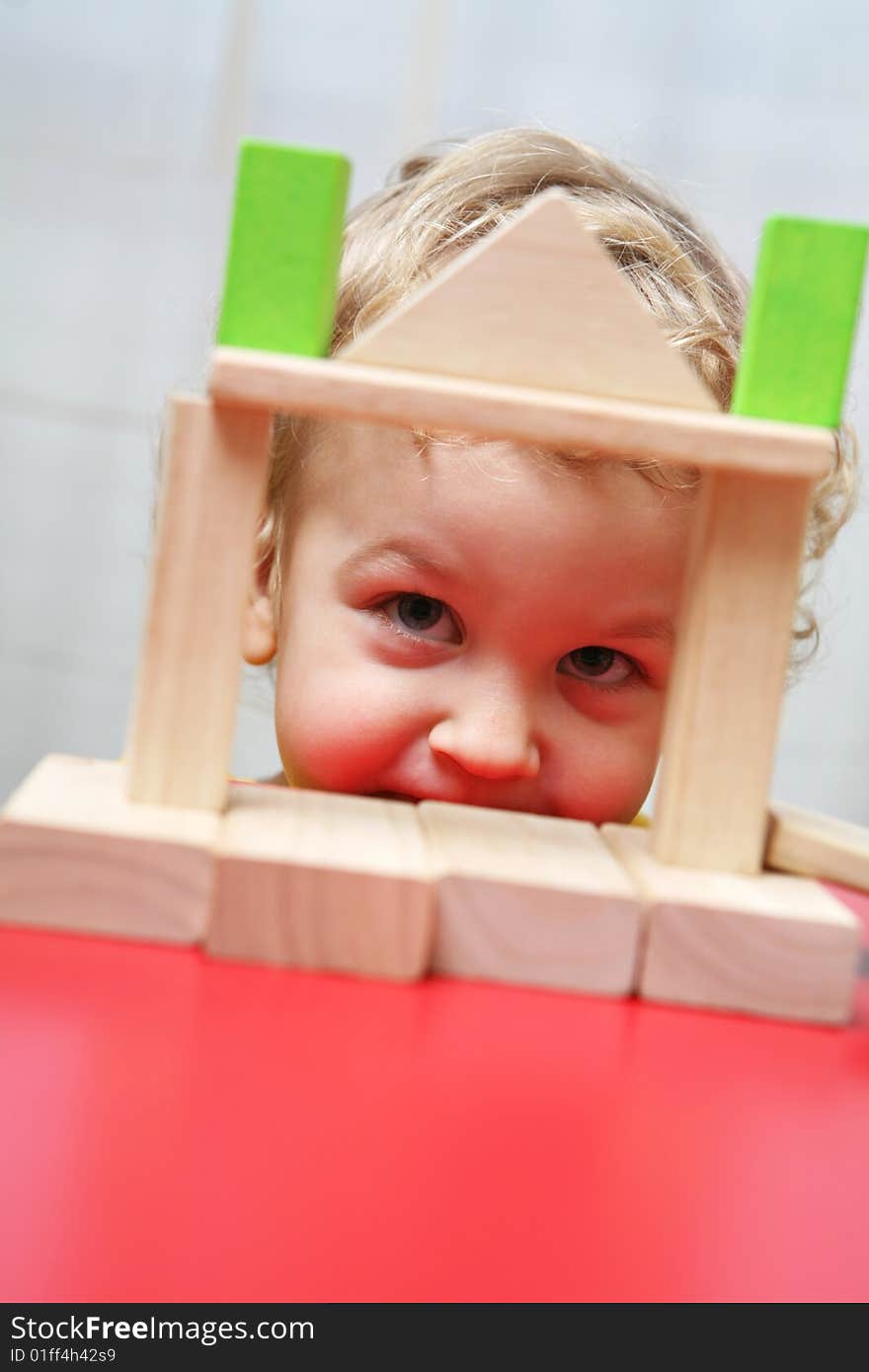 Kid is playing with colorful blocks. Kid is playing with colorful blocks.