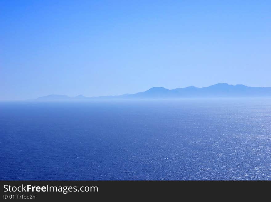 Mountain range at the coast in blue tones good as background