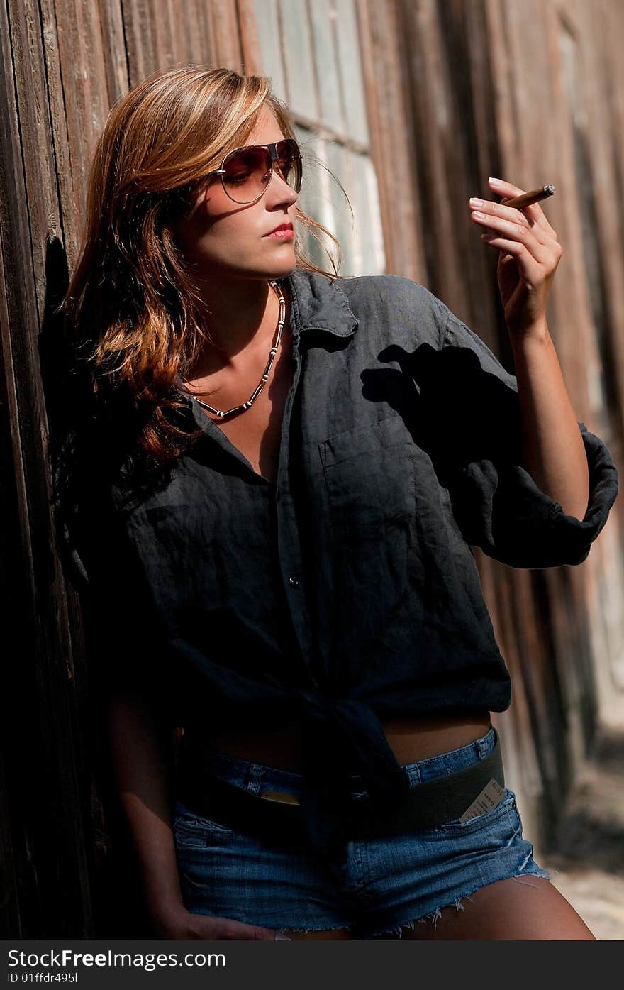 Young woman posing with cigar