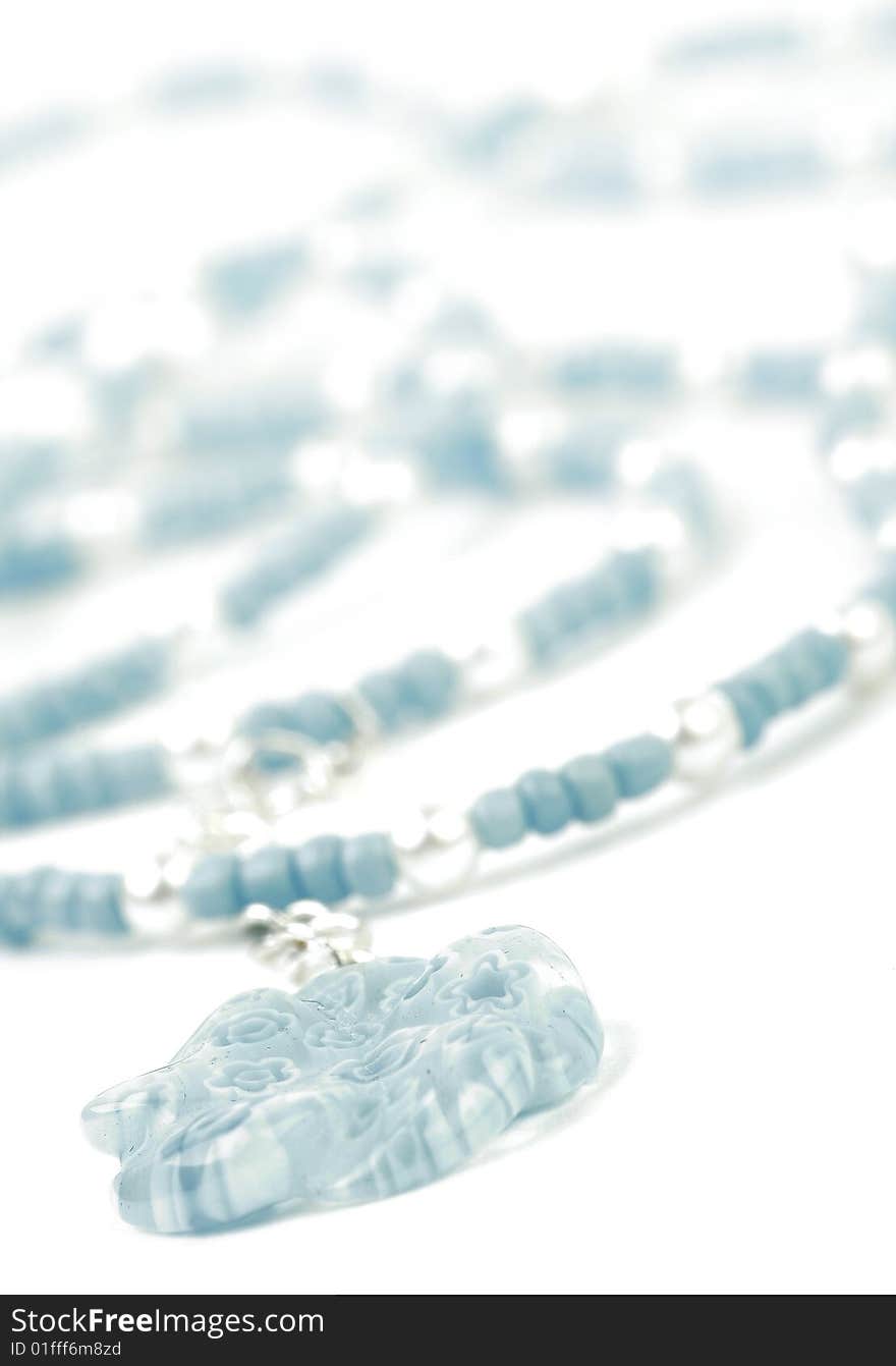 Necklace with Beads in Blue and Silver. White background. Side view with soft focus..