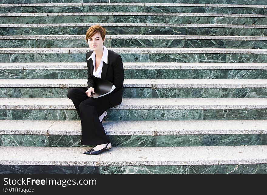 Young businesswoman over marble steps background.