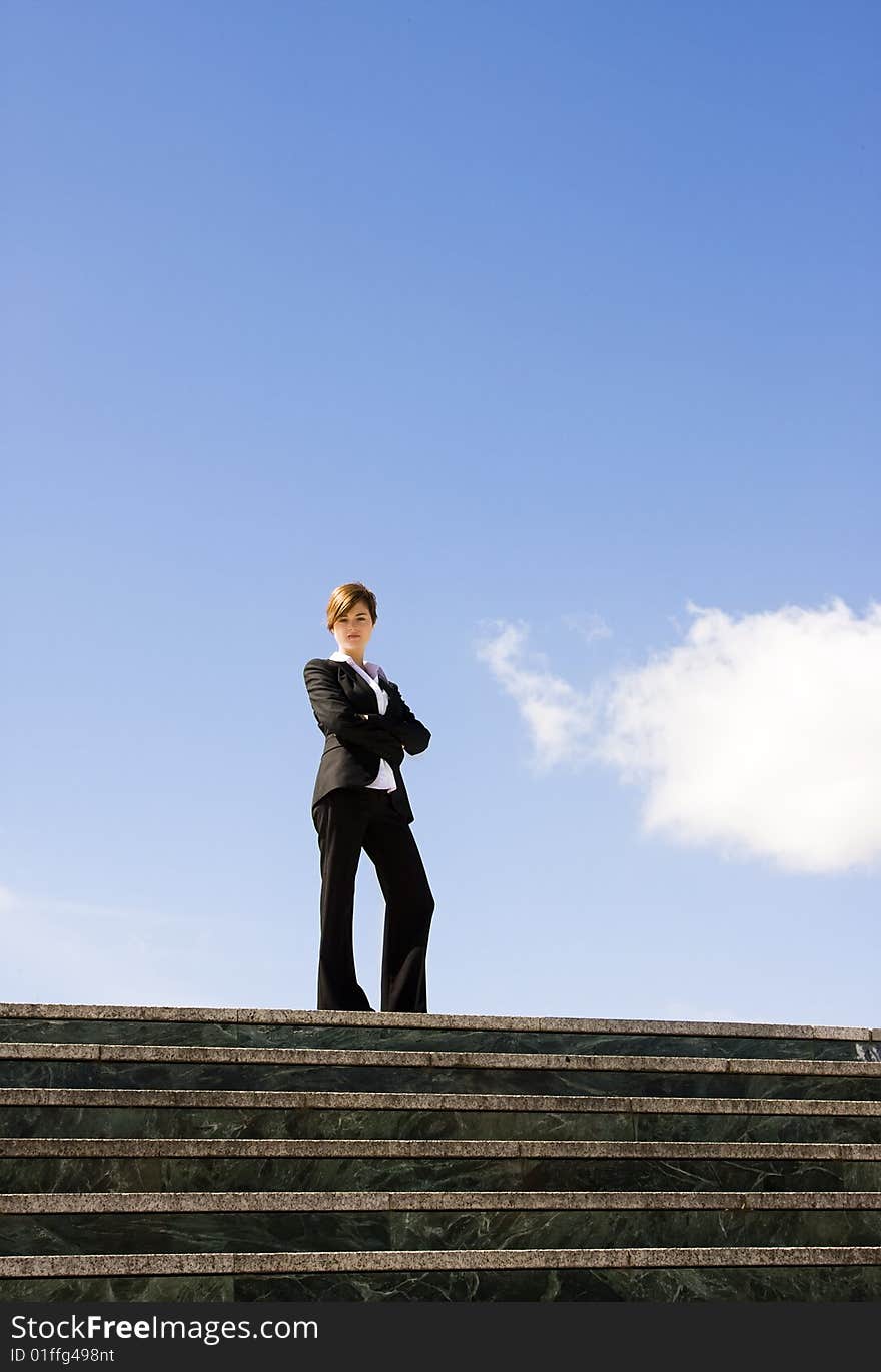 Businesswoman posing against huge cloudscape. Businesswoman posing against huge cloudscape.