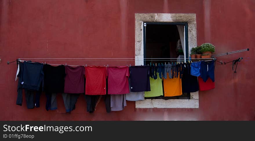 Old building with clothes hanging from a line over the window. Old building with clothes hanging from a line over the window