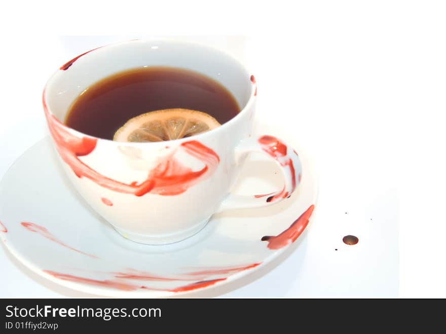 Cup of tea with blood smeared around it. Tea has lemon in it. Can be used for any drink hot drink isolated on white. Cup of tea with blood smeared around it. Tea has lemon in it. Can be used for any drink hot drink isolated on white