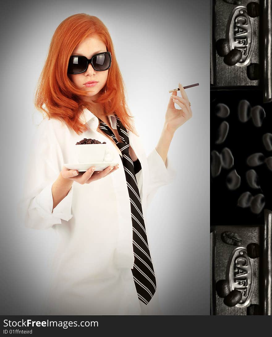 Young red-haired girl in the dress of the secretary poses with a coffee cup. Pictures well approach for advertising of coffee and cafe. Young red-haired girl in the dress of the secretary poses with a coffee cup. Pictures well approach for advertising of coffee and cafe