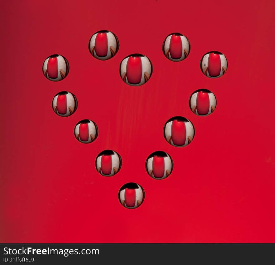 Water drops in the form of heart on a celebratory background