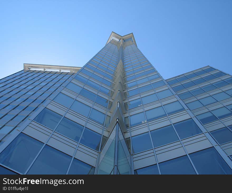 A tall modern glass building. A tall modern glass building