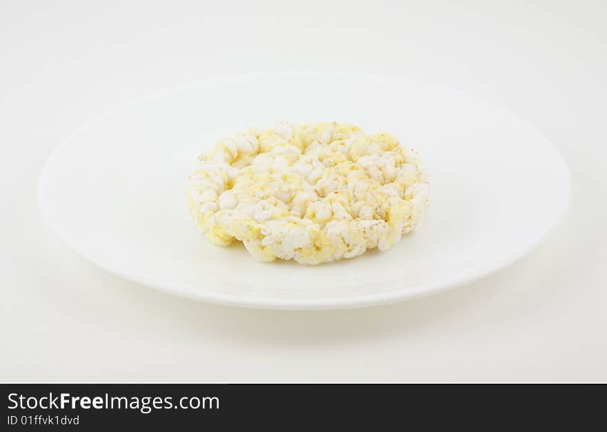 Rice cake on a white plate.  The ultimate low calorie food.