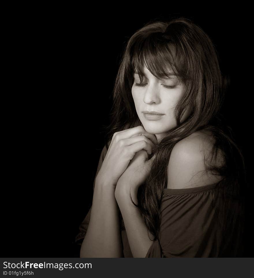 Beautiful brunette woman enjoying the moment on black background