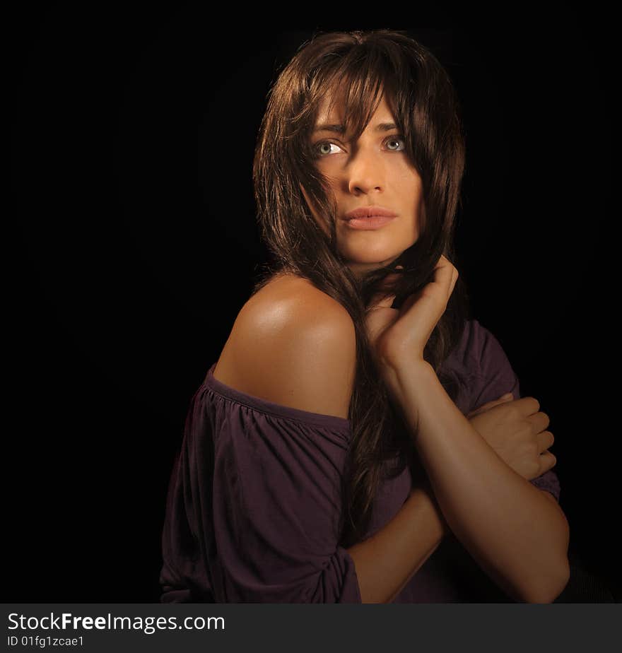 Beautiful brunette woman on black background