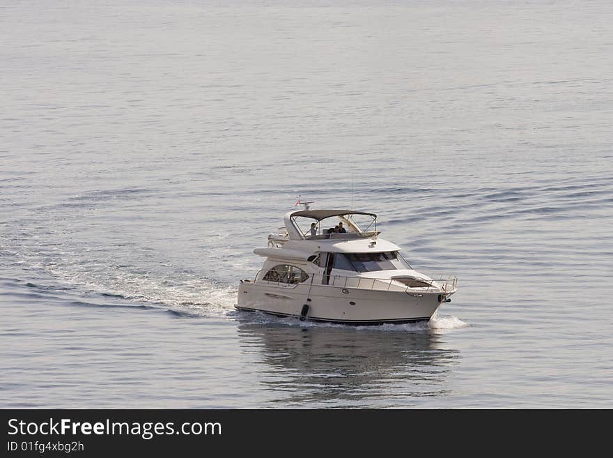 Yacht Curving Through Bay